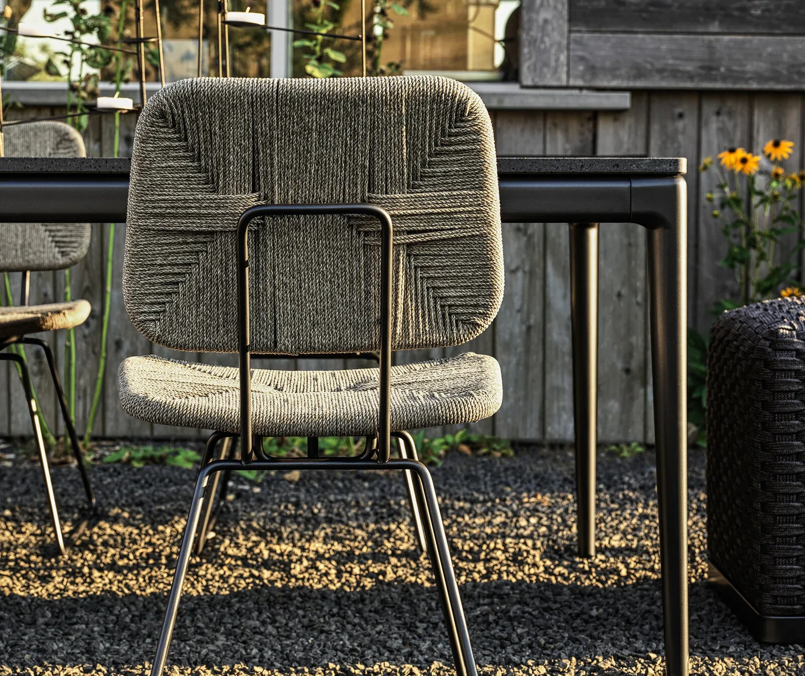 Flexform Echoes outdoor chair in a garden setting, frame 1