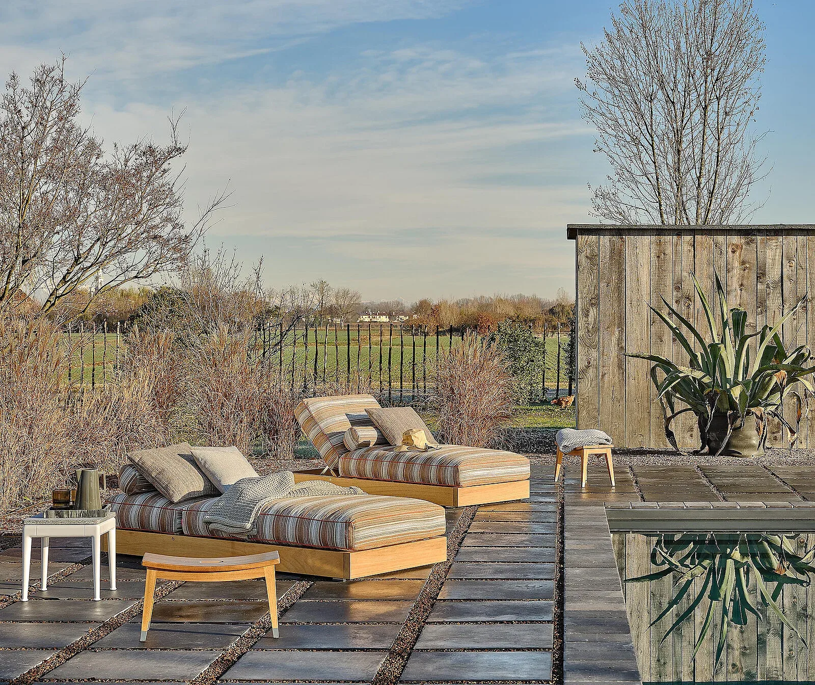 Flexform Hamptons outdoor daybed in a garden setting, frame 1