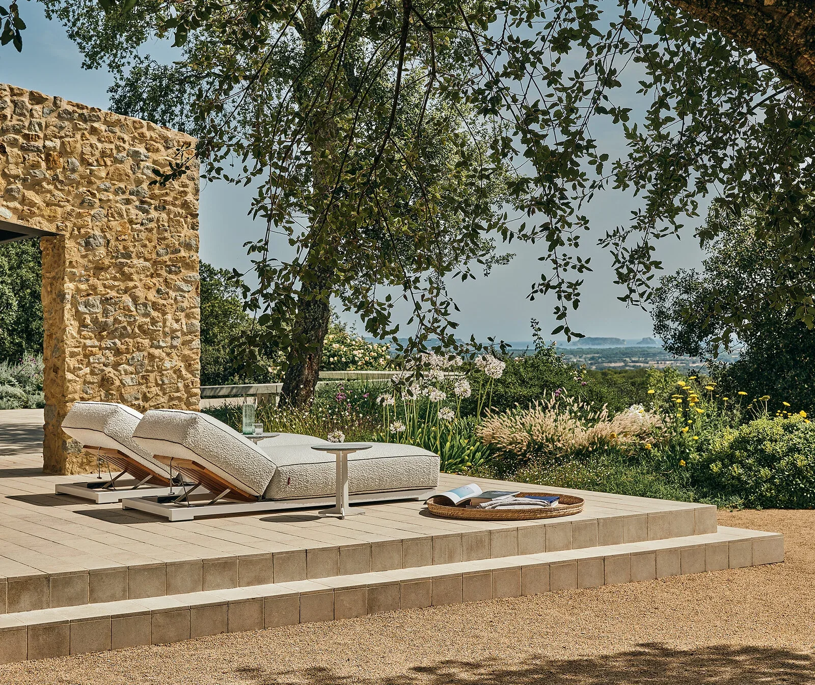 Flexform Milos outdoor daybed in a garden setting, frame 1