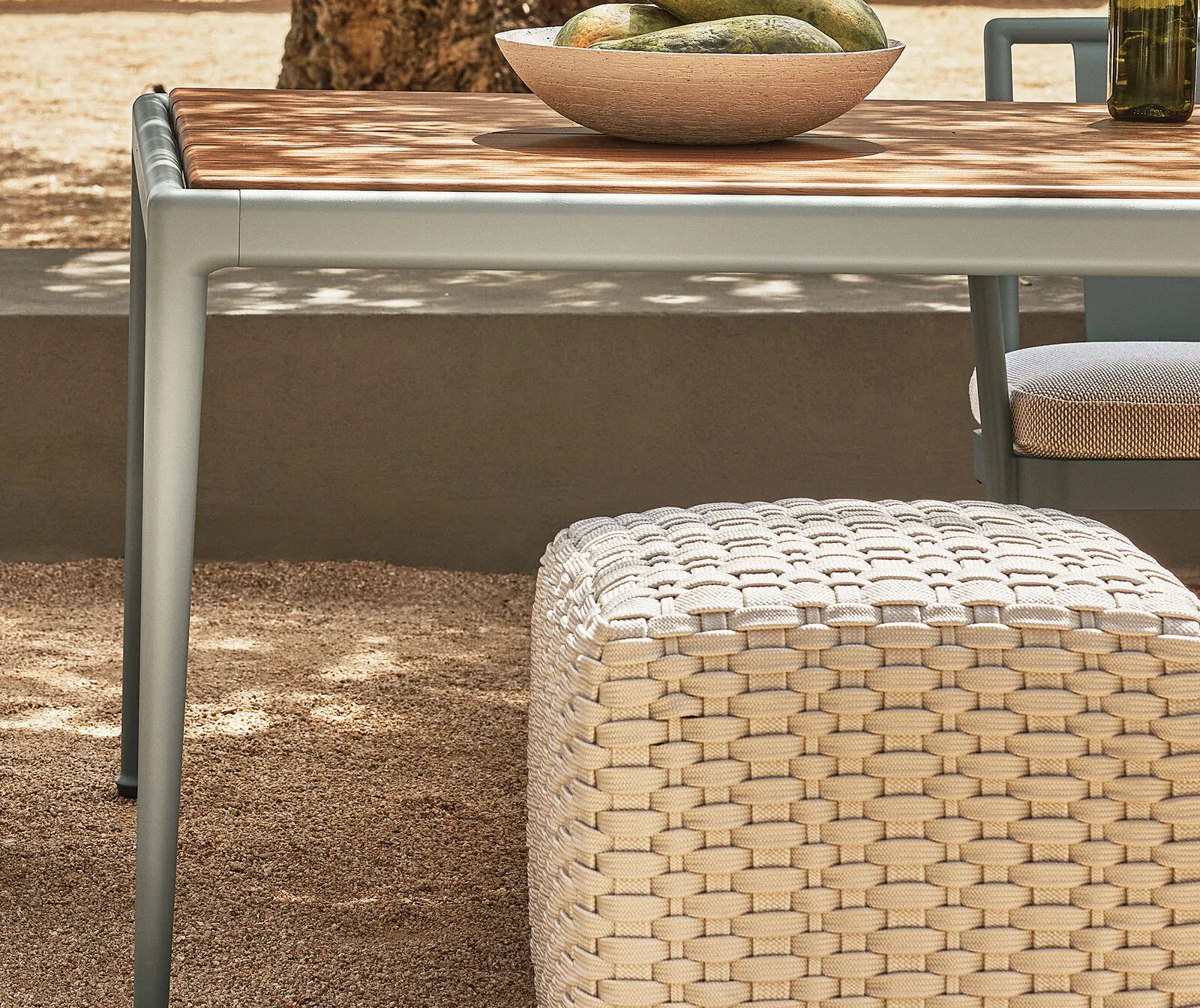 Flexform Phuket outdoor ottoman in a garden setting, frame 2