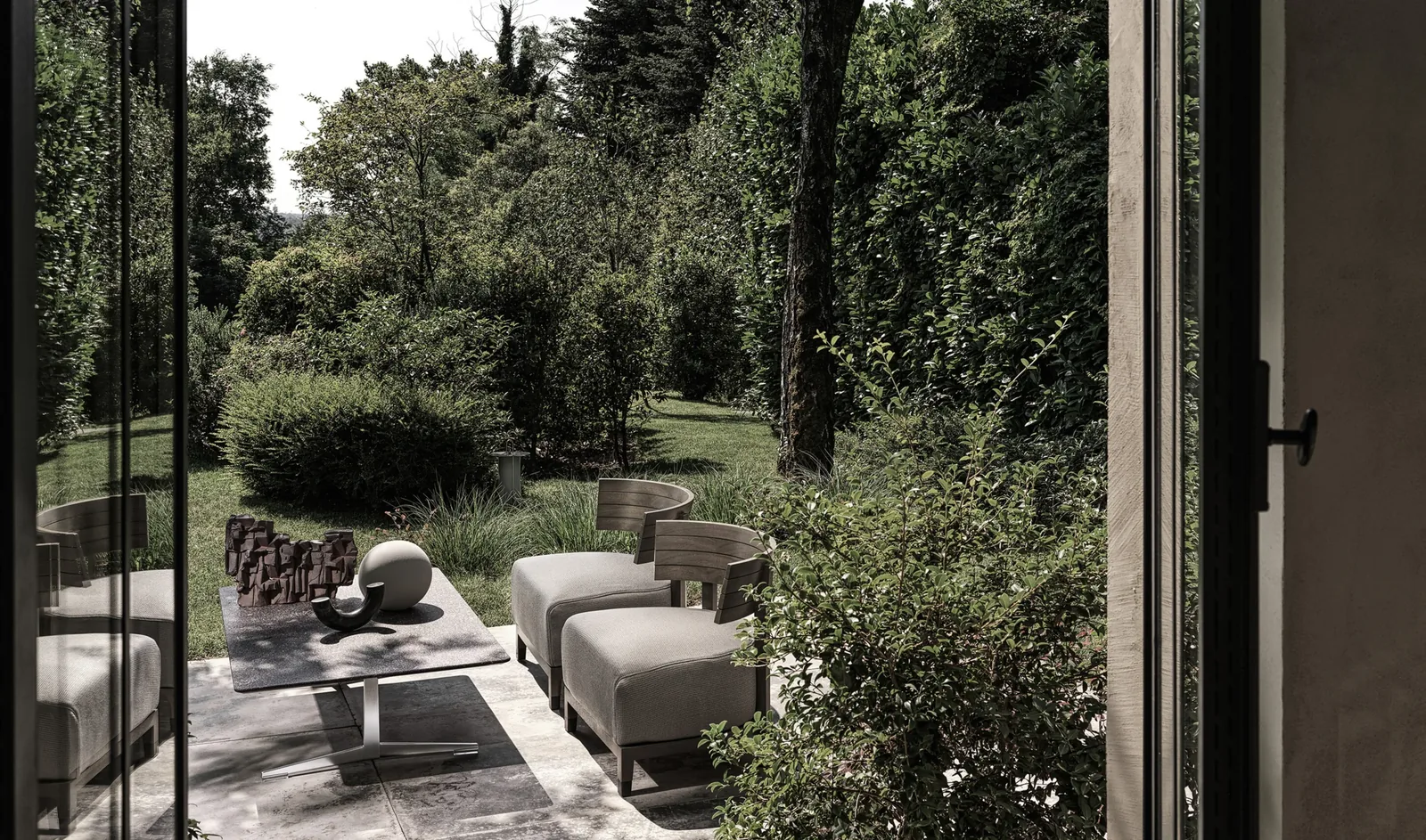 Flexform Thomas outdoor armchair in a garden setting, frame 1